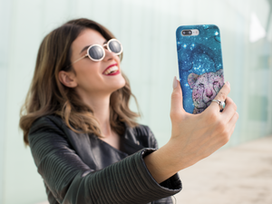 Woman holding a Cheetah Stars phone taking a selfie