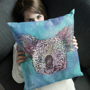 A cushion featuring a koala on a galaxy inspired blue background