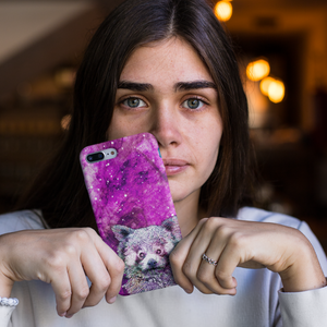 Woman holding a Red Panda phone case with a pink galaxy and stars background
